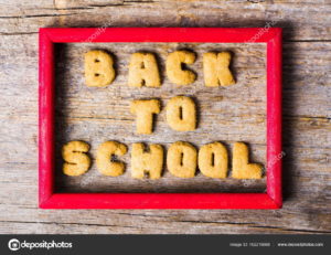 Back to school written with cookies on a wooden table